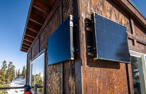 Goal Zero Boulder solar panels mounted on the side of a small shack