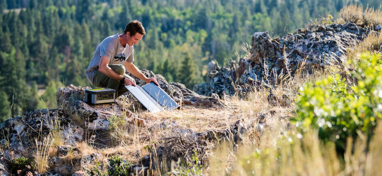 Man using Goal Zero Nomad solar panel to collect solar energy for Yeti X power station